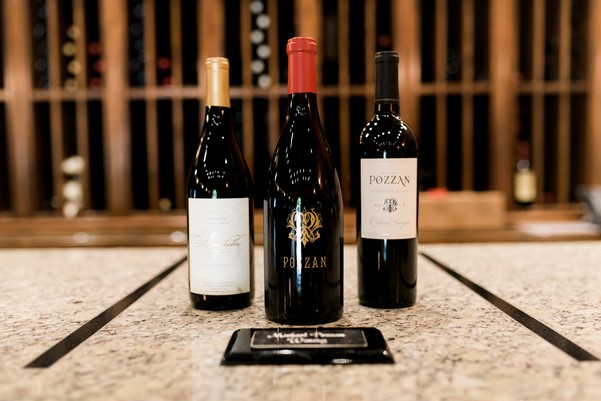 Three bottles of wine presented on a marble table