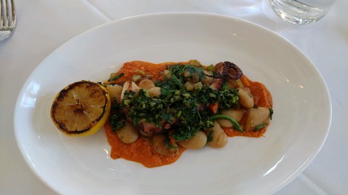 grilled octopus with braised greens and gigante beans in a Romesco sauce