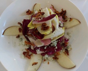 endive salad with sliced red pears and gorgonzola cheese