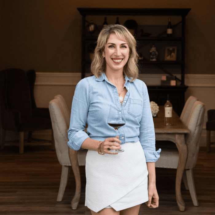 A photo of Kimberly Pozzan standing in front of the Michael Pozzan Winery