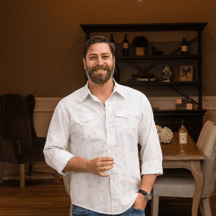 A photo of Matthew Pozzan standing in front of Michael Pozzan winery